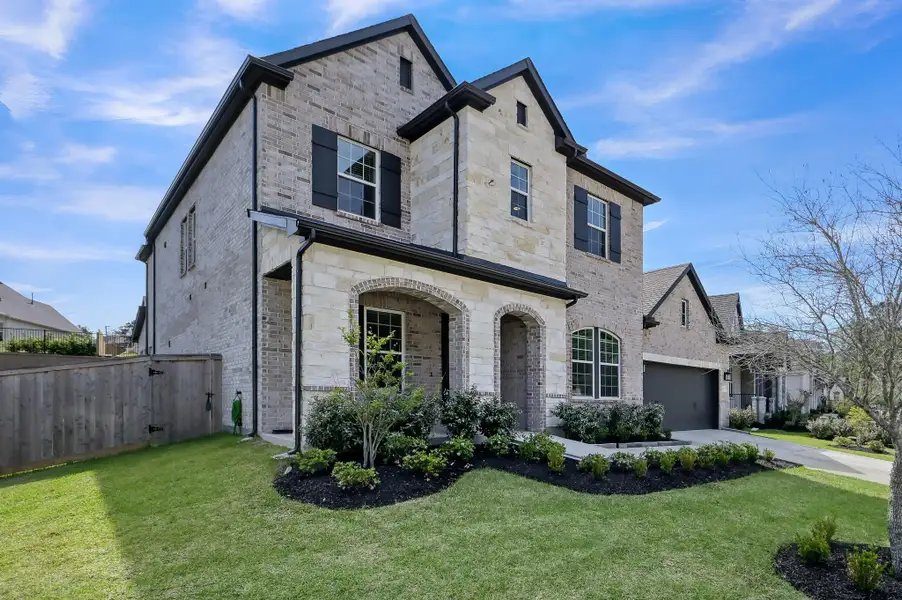 Front exterior of a new home in The Woodlands Hills 60’, Willis, TX, highlighting curb appeal (Image 24).