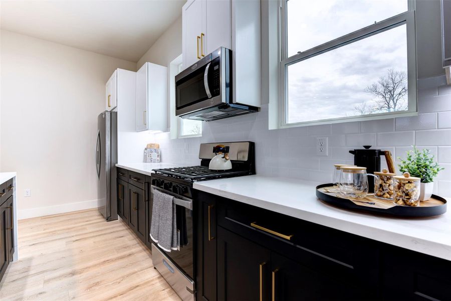Black cabinets with brass hardware throughout the home Black cabinets with brass hardware throughout the home