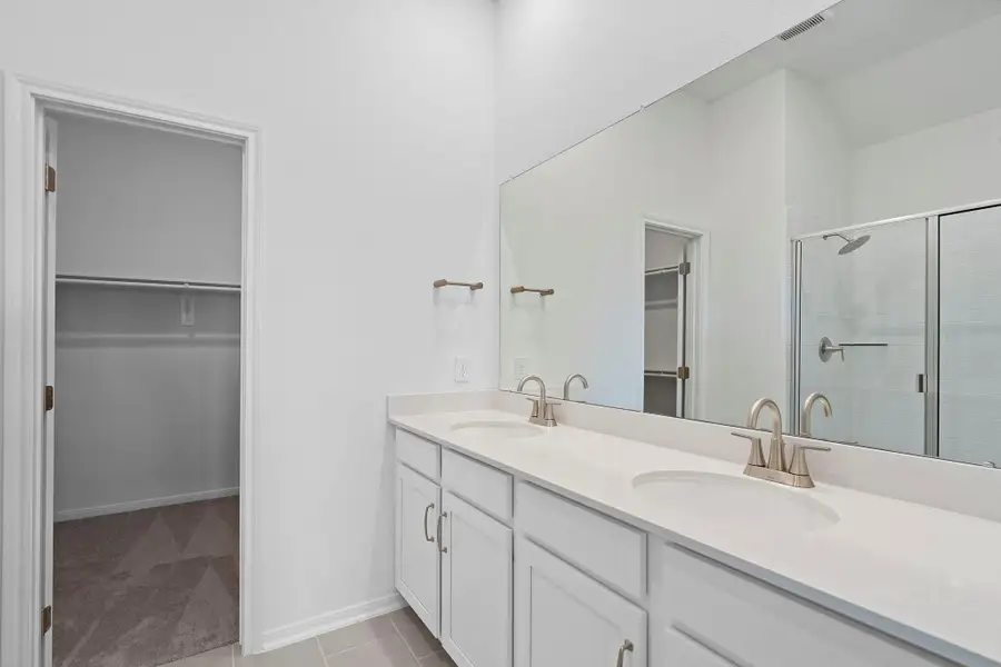 The en-suite bathroom offers a spa-like atmosphere with its elegant design, high end finishes, and tasteful lighting, creating a retreat within your own home. The en-suite bathroom offers a spa-like atmosphere with its elegant design, high end finishes, and tasteful lighting, creating a retreat within your own home.