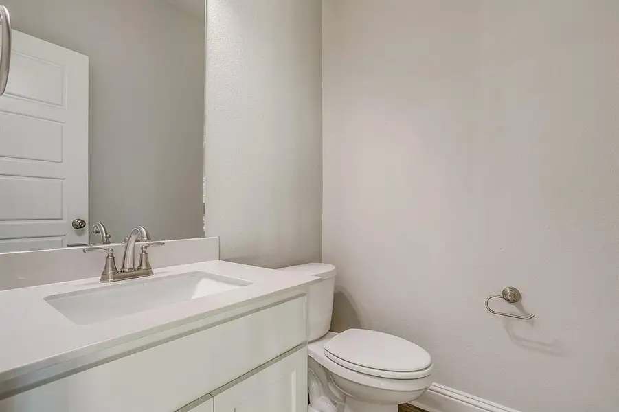 Bathroom featuring vanity and a textured wall Bathroom featuring vanity and a textured wall