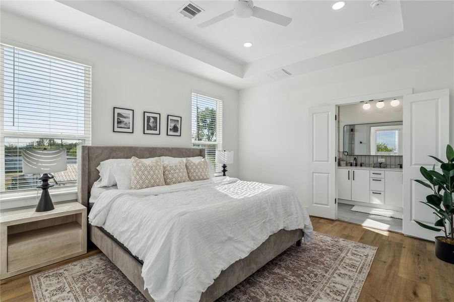 Vecino homes signature primary bedroom features plenty of natural light and wide plank vinyl floors.