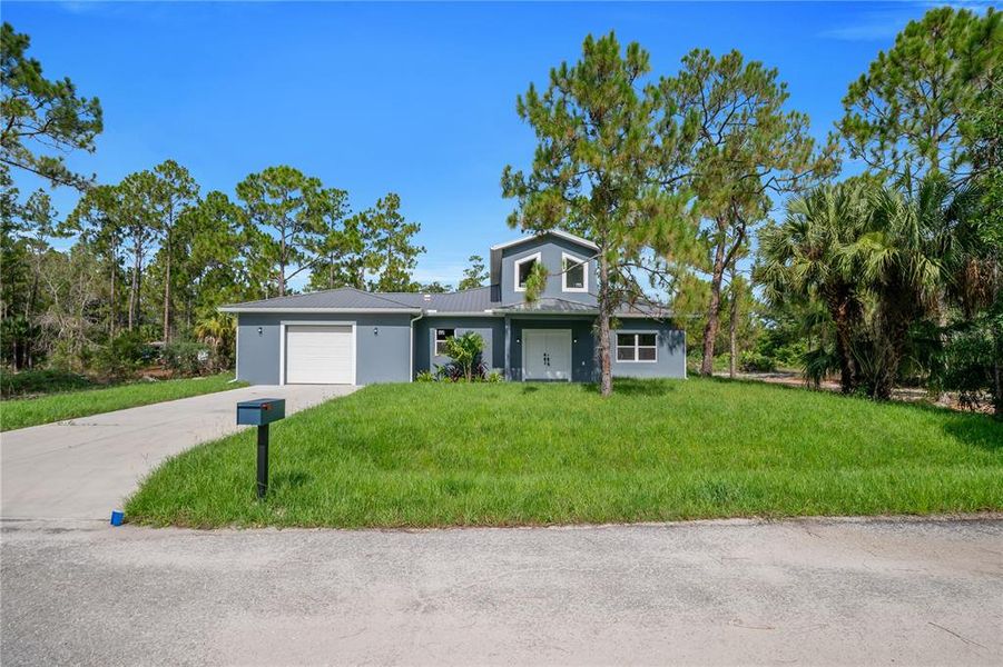 Front exterior of a new home in , Lehigh Acres, FL, highlighting curb appeal (Image 24).