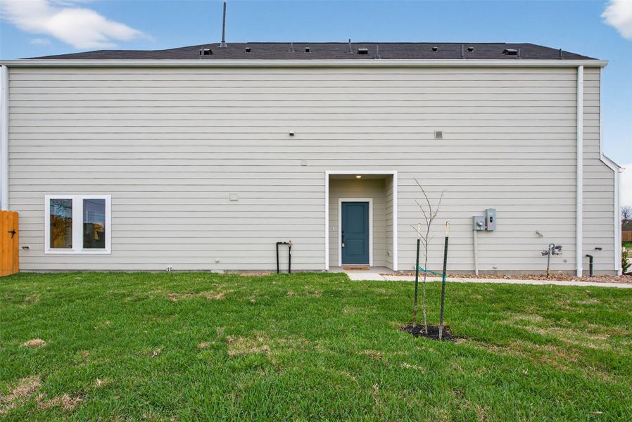 Well-maintained backyard with convenient access to the home, showcasing functional design and outdoor versatility. Well-maintained backyard with convenient access to the home, showcasing functional design and outdoor versatility.