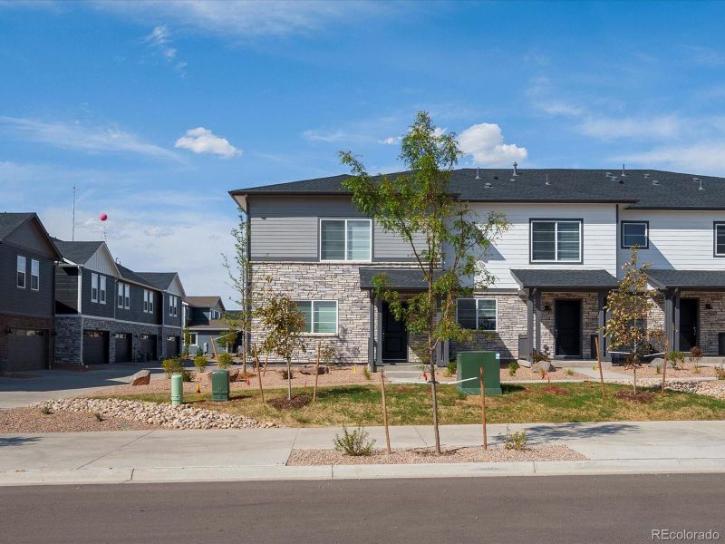 Front exterior of a new home in Skyview at High Point, Aurora, CO, highlighting curb appeal (Image 22).