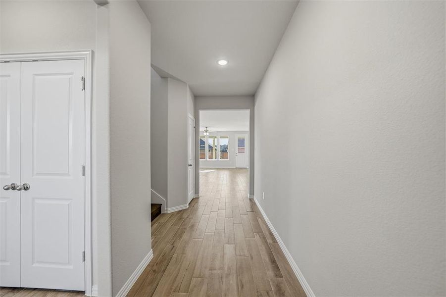 Hallway featuring light wood-style flooring and recessed lighting Hallway featuring light wood-style flooring and recessed lighting