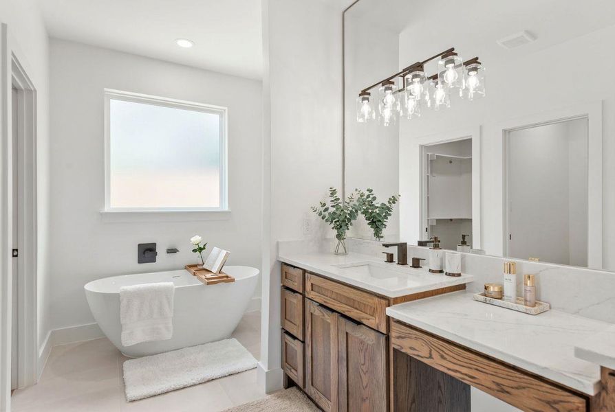 Wake up to luxury in this stunning primary bathroom, featuring a freestanding tub and his & her closets—just the perfect way to start your day!