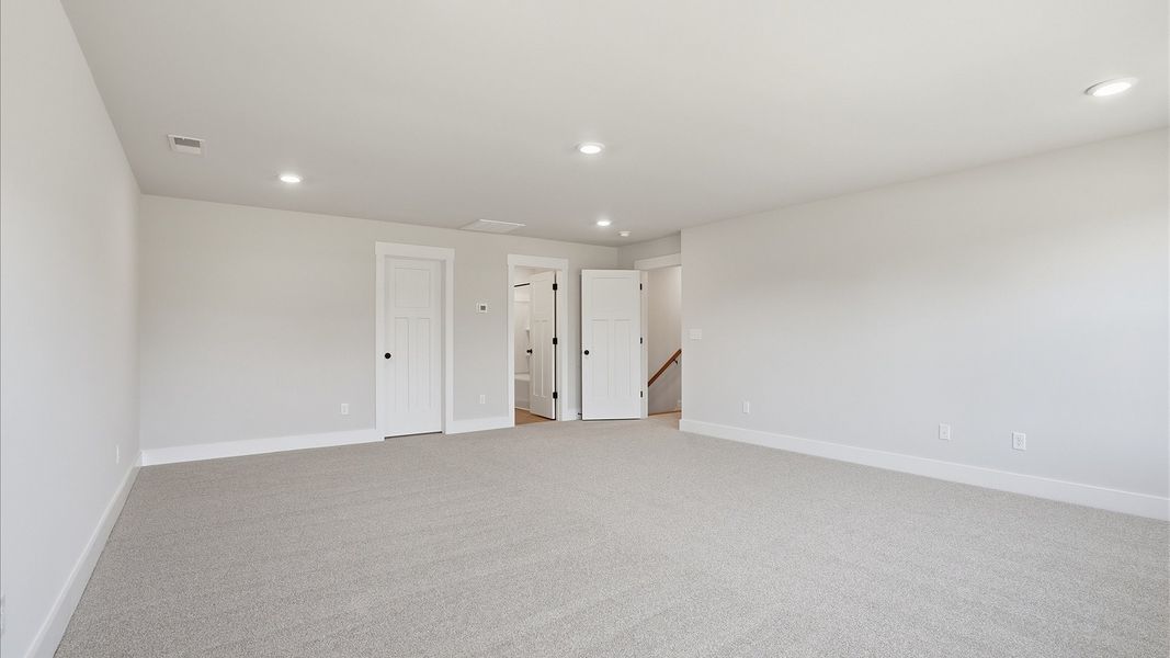Memorable upstairs room with plush carpeting and a bright, welcoming atmosphere Memorable upstairs room with plush carpeting and a bright, welcoming atmosphere