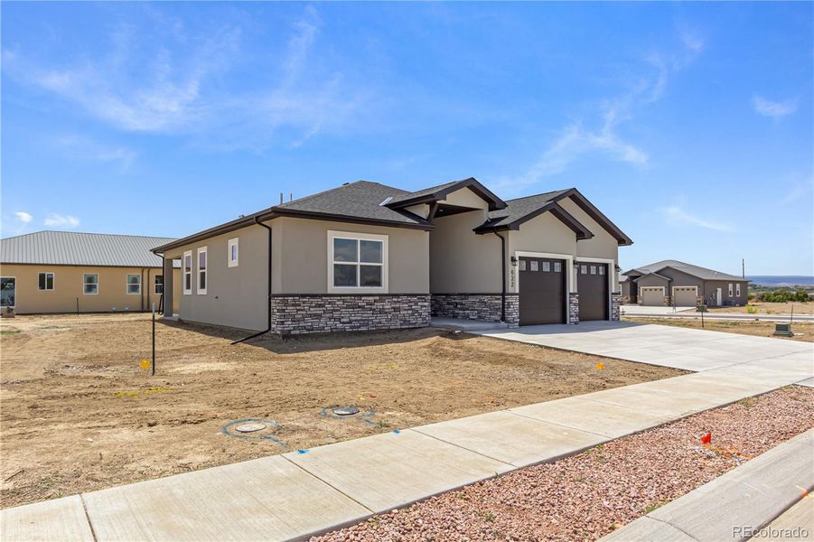 Front exterior of a new home in , Montrose, CO, highlighting curb appeal (Image 1). Front exterior of a new home in , Montrose, CO, highlighting curb appeal (Image 1).