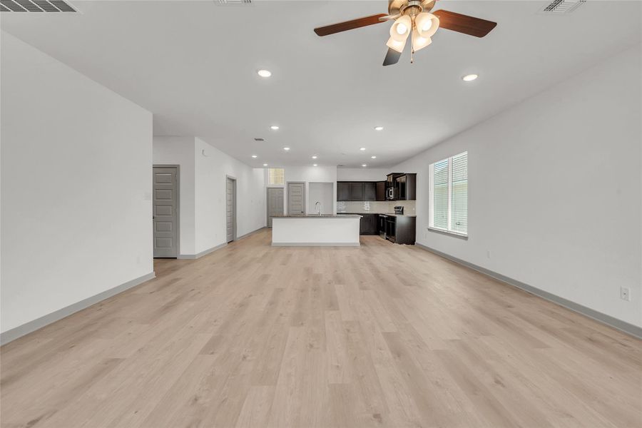 Unfurnished living room featuring recessed lighting, light wood-style floors, and a ceiling fan