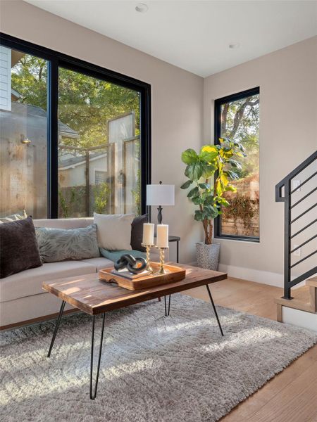 Living area with stairway and light wood-type flooring