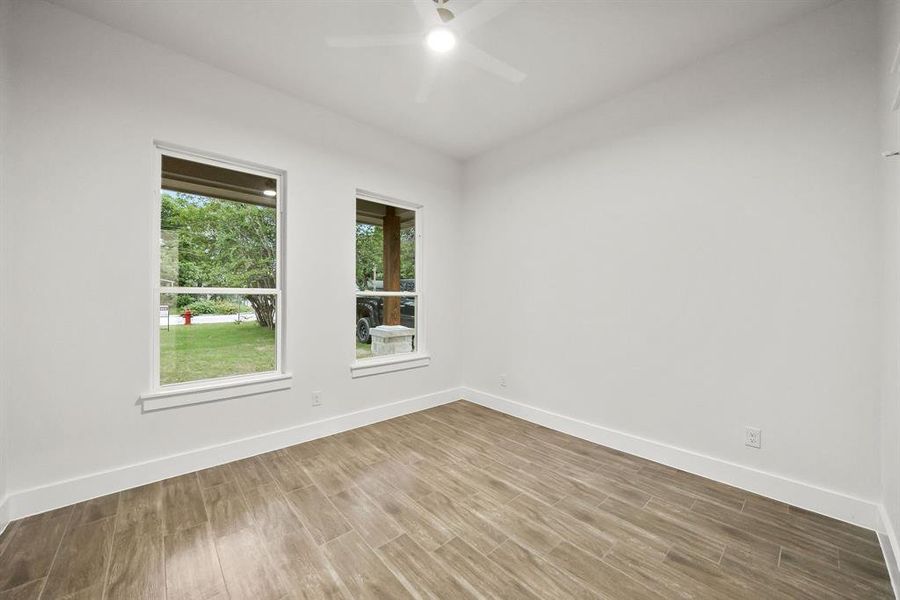 Interior space featuring wood-finish flooring, white walls, and bright white trim