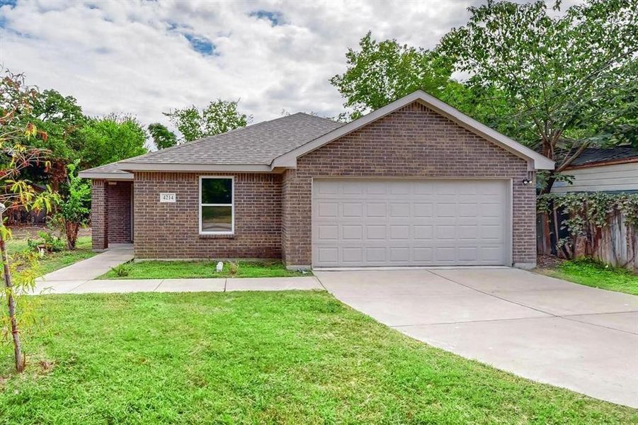 Ranch-style home with a front yard and a garage