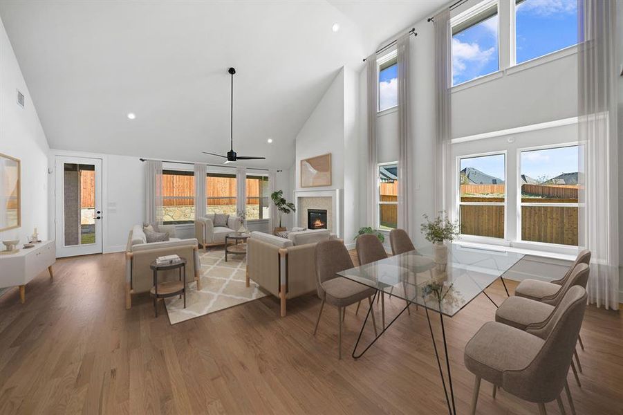 Dining room with high vaulted ceiling, healthy amount of natural light, a glass covered fireplace, recessed lighting, and wood finished floors Dining room with high vaulted ceiling, healthy amount of natural light, a glass covered fireplace, recessed lighting, and wood finished floors