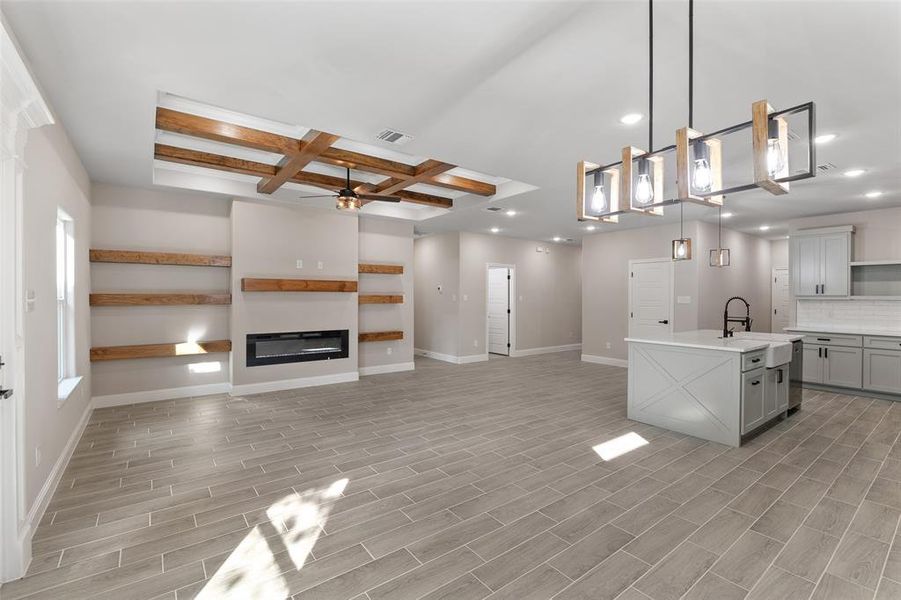 Kitchen with hanging light fixtures, beamed ceiling, tasteful backsplash, coffered ceiling, and ceiling fan