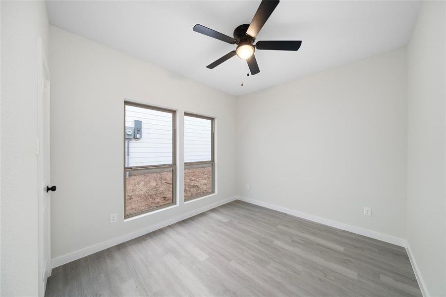 Spare room featuring light hardwood / wood-style flooring and ceiling fan