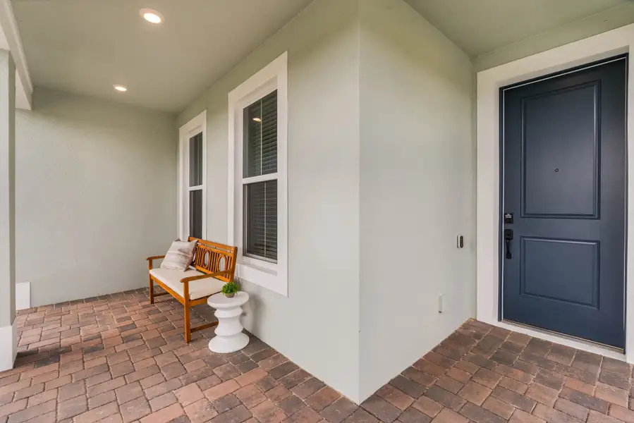 Exterior details and patio area of a home in Harvest at Ovation - Townhomes, Winter Garden (Image 2).