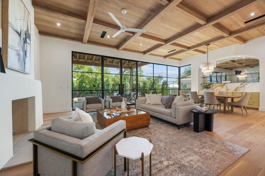 Warm wood ceilings and walls of glass define this open living area.