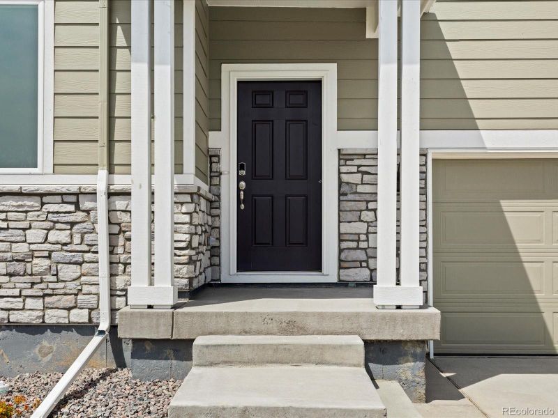 Front exterior of a new home in Revere at Johnstown, Johnstown, CO, highlighting curb appeal (Image 1).