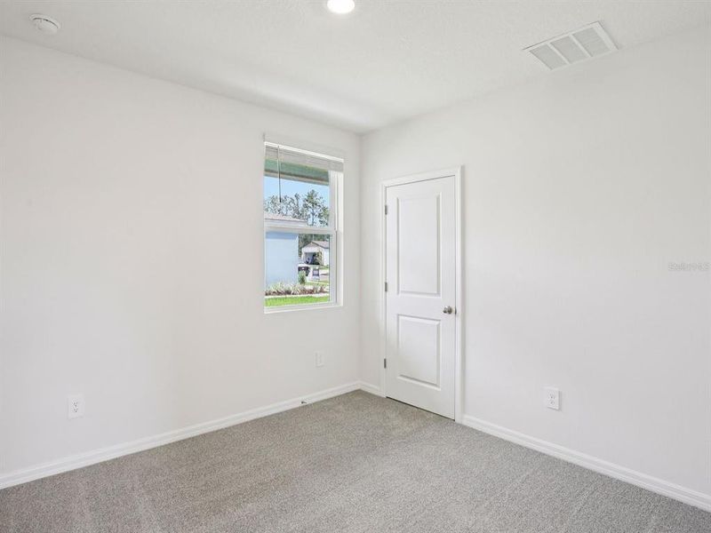 Spacious, unfurnished interior of a new home in The Grove at Stuart Crossing - Premier Series, Bartow (Image 16).