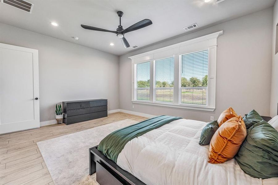 Bedroom with recessed lighting, wood finished floors, and a ceiling fan
