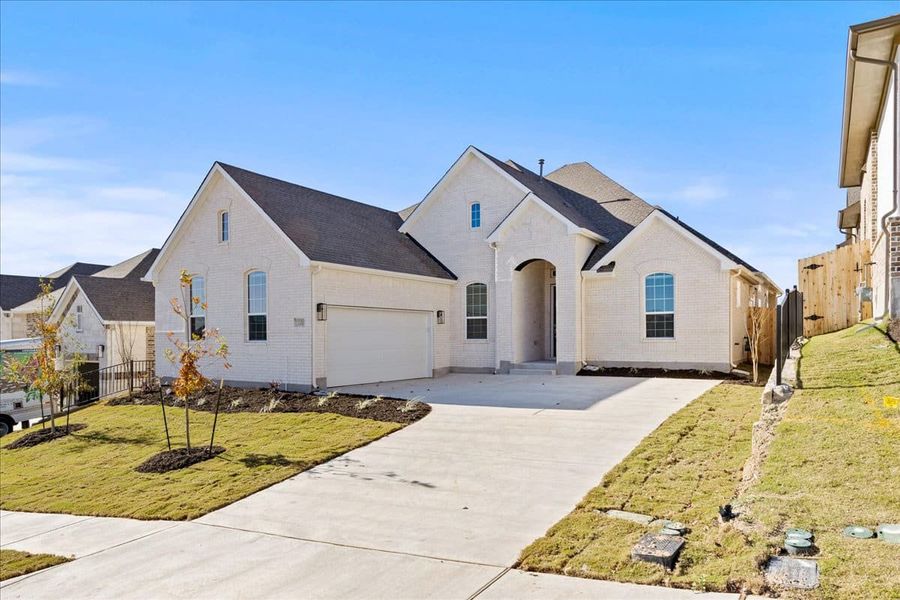 Front exterior of a new home in Sunfield, Buda, TX, highlighting curb appeal (Image 23).