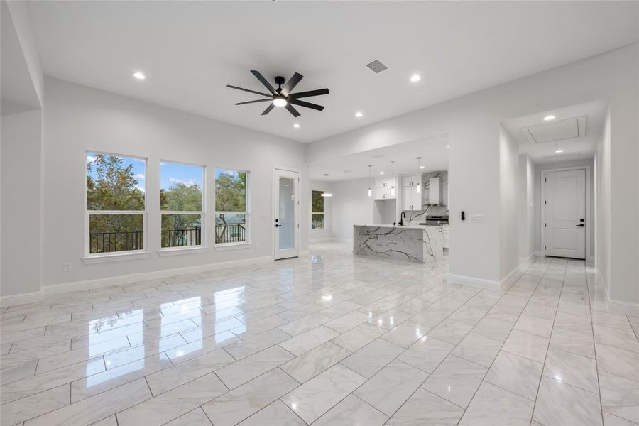 Unfurnished living room with a ceiling fan and recessed lighting