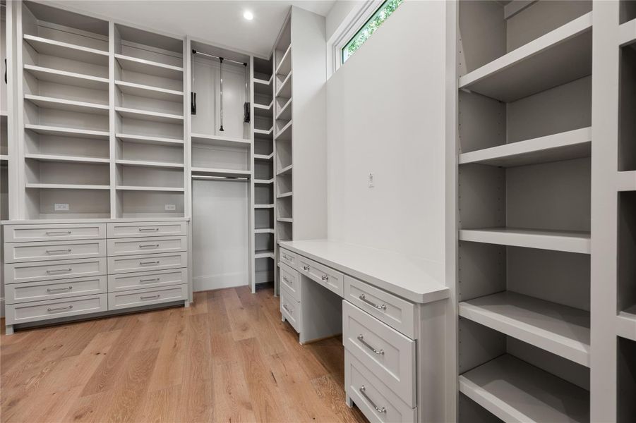 High ceilings, a vanity area, and plenty of storage make this a closet of dreams.