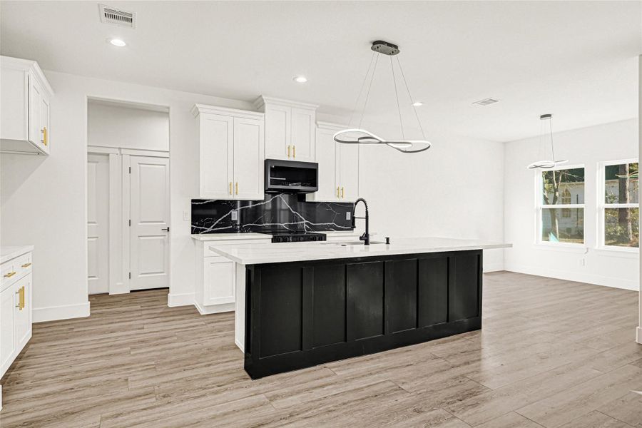 Large kitchen island with decorative chandelier