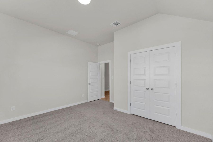 Bedroom in the Pecos home plan by Trophy Signature Homes – REPRESENTATIVE PHOTO