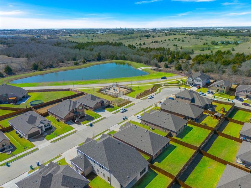 Drone / aerial view with a water view and a residential view.