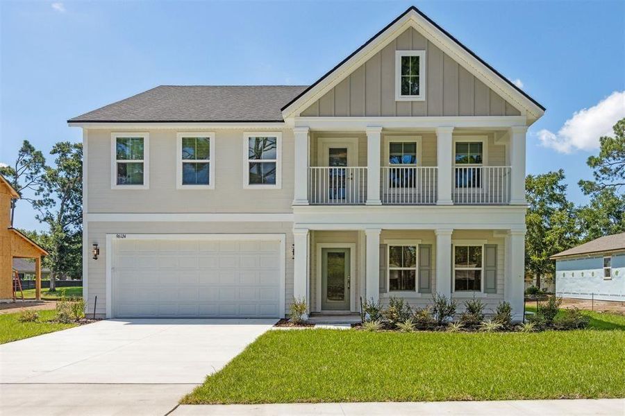 Front exterior of a new home in Pirates Bluff, Yulee, FL, highlighting curb appeal (Image 1).