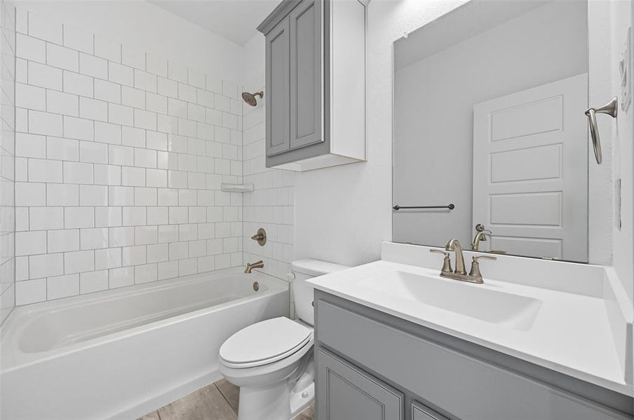 Full bath featuring shower / bath combination and vanity