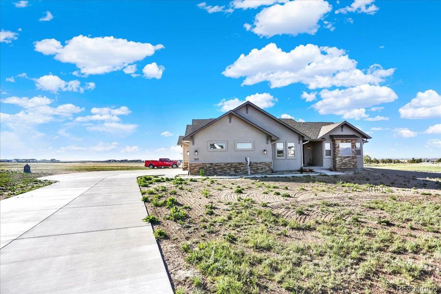 Front exterior of a new home in , Colorado Springs, CO, highlighting curb appeal (Image 24).