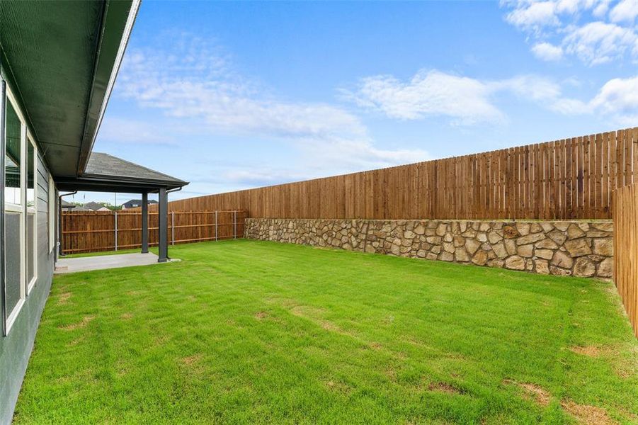 Fenced backyard with a patio Fenced backyard with a patio