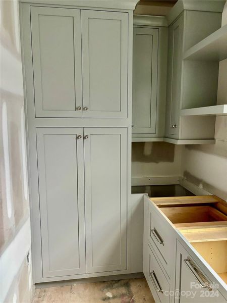 Interior View of Scullery w/ pantry shelving on both ends