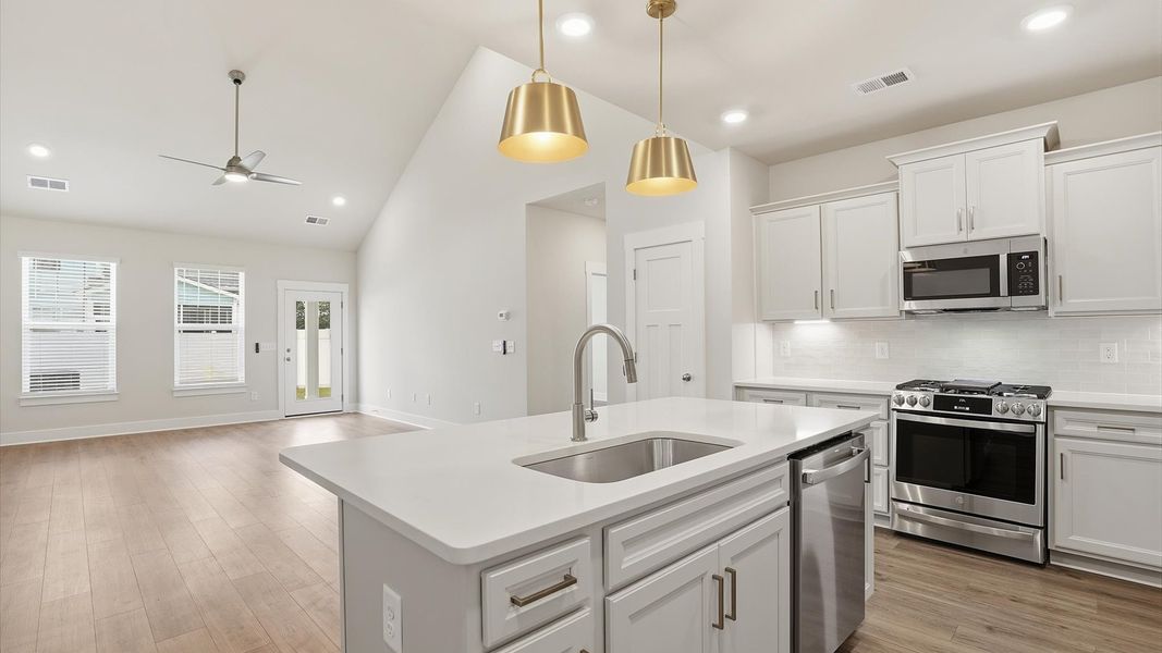 Bright and airy culinary space with generous prep areas and contemporary lighting at Village at Midway Bright and airy culinary space with generous prep areas and contemporary lighting at Village at Midway