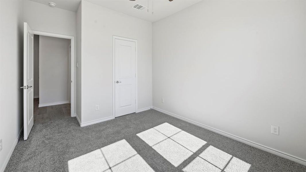 Unfurnished bedroom featuring carpet flooring and baseboards Unfurnished bedroom featuring carpet flooring and baseboards