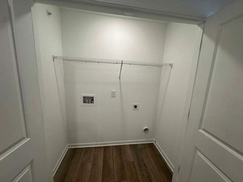 Laundry Room Conveniently Located Near the Primary Suite