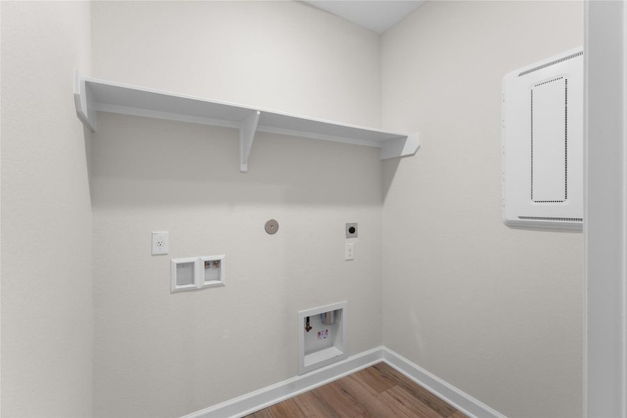 Dedicated utility room with washer and dryer connections, built-in storage shelf, and convenient access to the home's main living areas Dedicated utility room with washer and dryer connections, built-in storage shelf, and convenient access to the home's main living areas