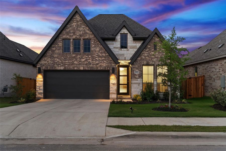 Brick and stone facade featuring a prominent gable roofline