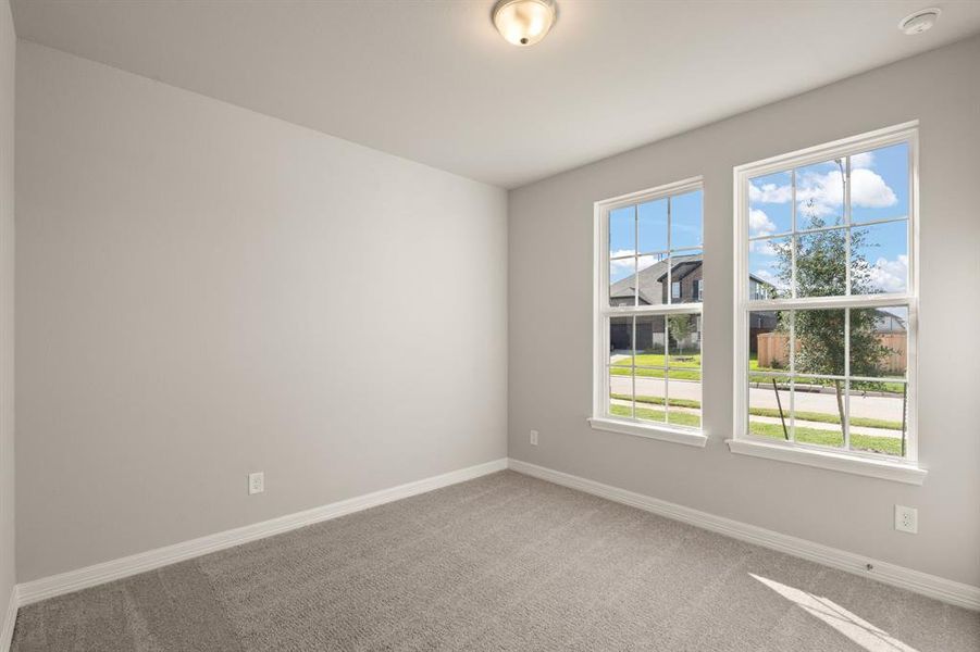 Your secondary bedroom features plush carpet, fresh paint, closet, and a large window that lets in plenty of natural lighting.