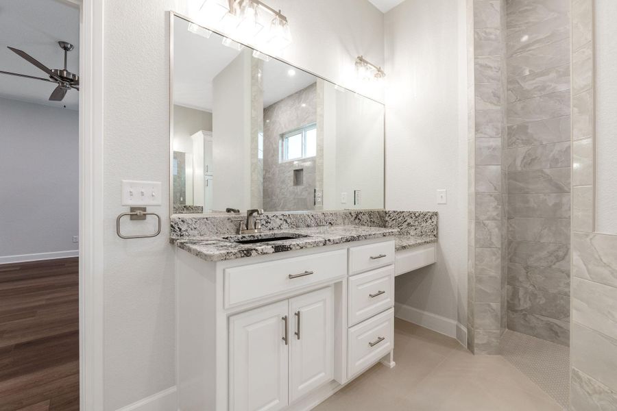 Full bathroom featuring vanity, a walk in shower, and ceiling fan