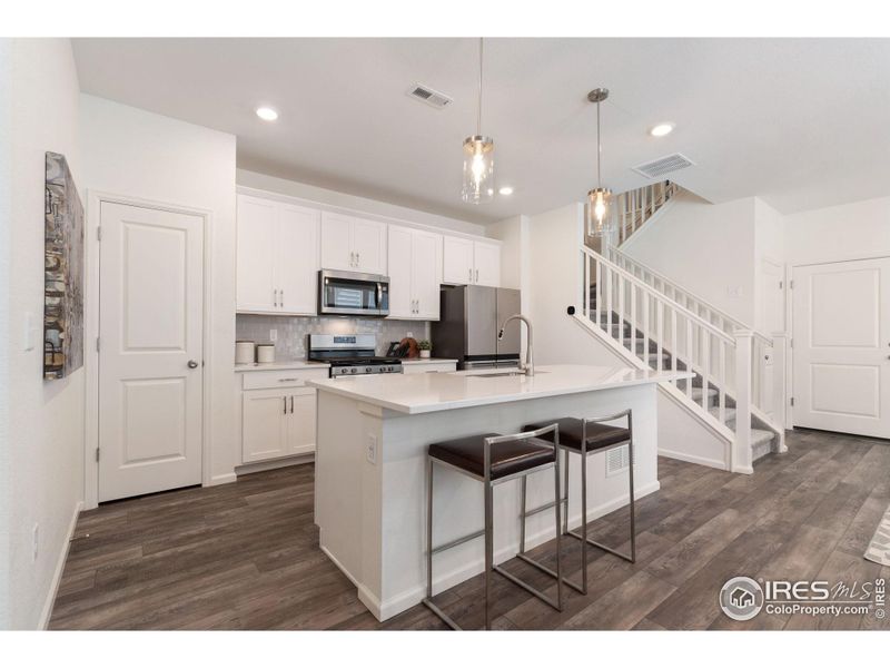 Dream Kitchen with Pendant Lighting, Stainless Steel Appliances, White Shaker Style Cabinets, Pantry