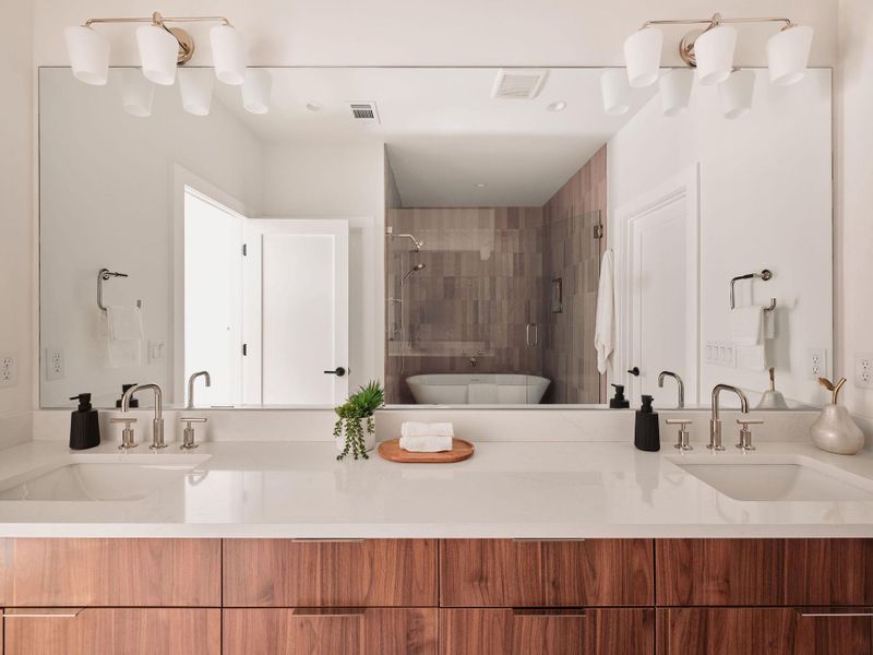 Full bath with double vanity, a shower stall, and a freestanding tub Full bath with double vanity, a shower stall, and a freestanding tub