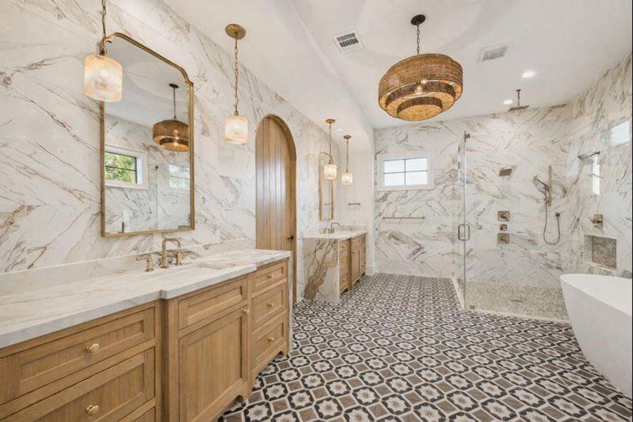 Primary bathroom is a retreat, with double vanities, floor to ceiling tile, walk-in shower, soaking tub and massive closet  *this photo has been virtually rendered based on a previous home constructed by the builder. 1519 Candlelight may have different selections at builders sole discretion. These photos are not meant to be an exact representation of 1519 Candlelight.