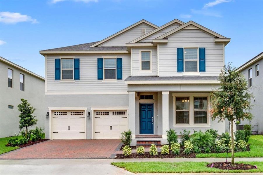 Front exterior of a new home in Waterleigh, Winter Garden, FL, highlighting curb appeal (Image 2).