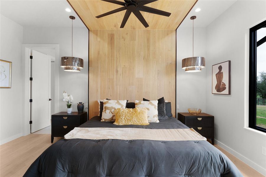 Master bedroom with custom wood accent wall. Master bedroom with custom wood accent wall.