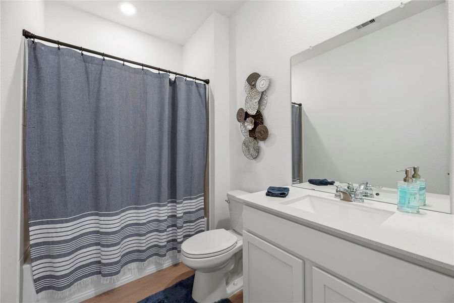 Secondary bathroom with modern finishes, clean vanity, and full tub and shower combination.
