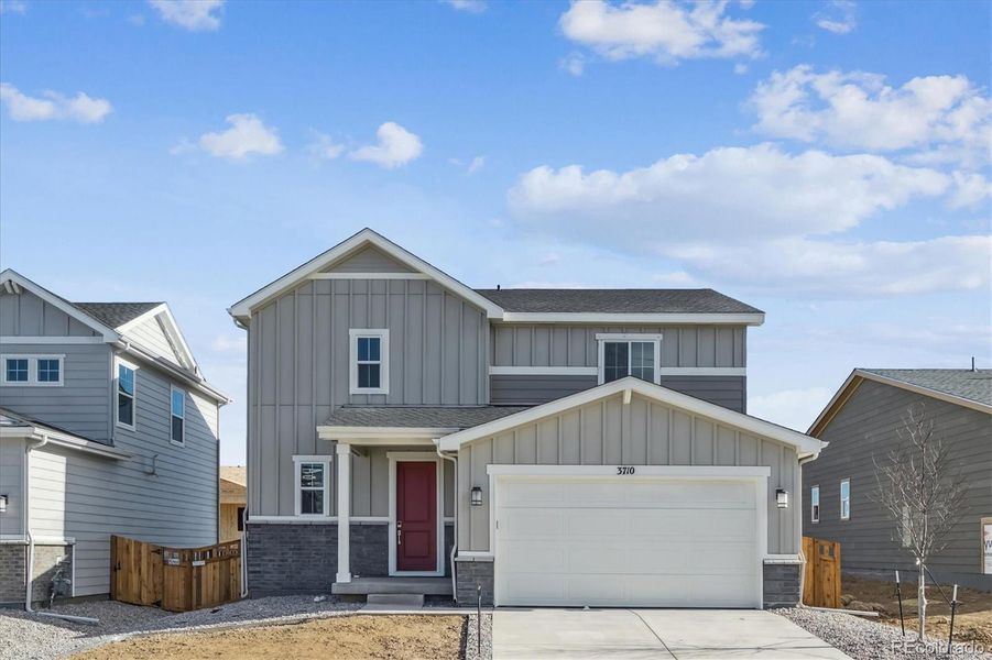 Front exterior of a new home in Sweetgrass, Dacono, CO, highlighting curb appeal (Image 2).