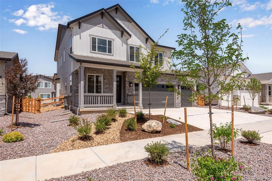 Front exterior of a new home in Prelude at The Aurora Highlands, Aurora, CO, highlighting curb appeal (Image 25). Front exterior of a new home in Prelude at The Aurora Highlands, Aurora, CO, highlighting curb appeal (Image 25).